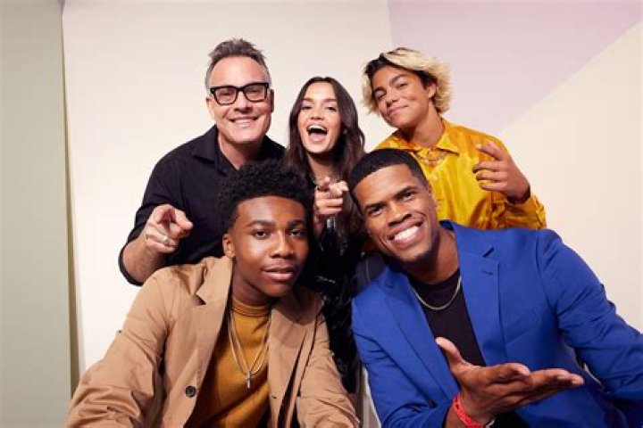 Simon wearing wraps around hands and waist with a red cape on